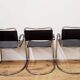 Three armchairs in black leather and steel tube