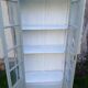 Parisian style display cabinet with 2 doors and 3 shelves in Luxembourg green.