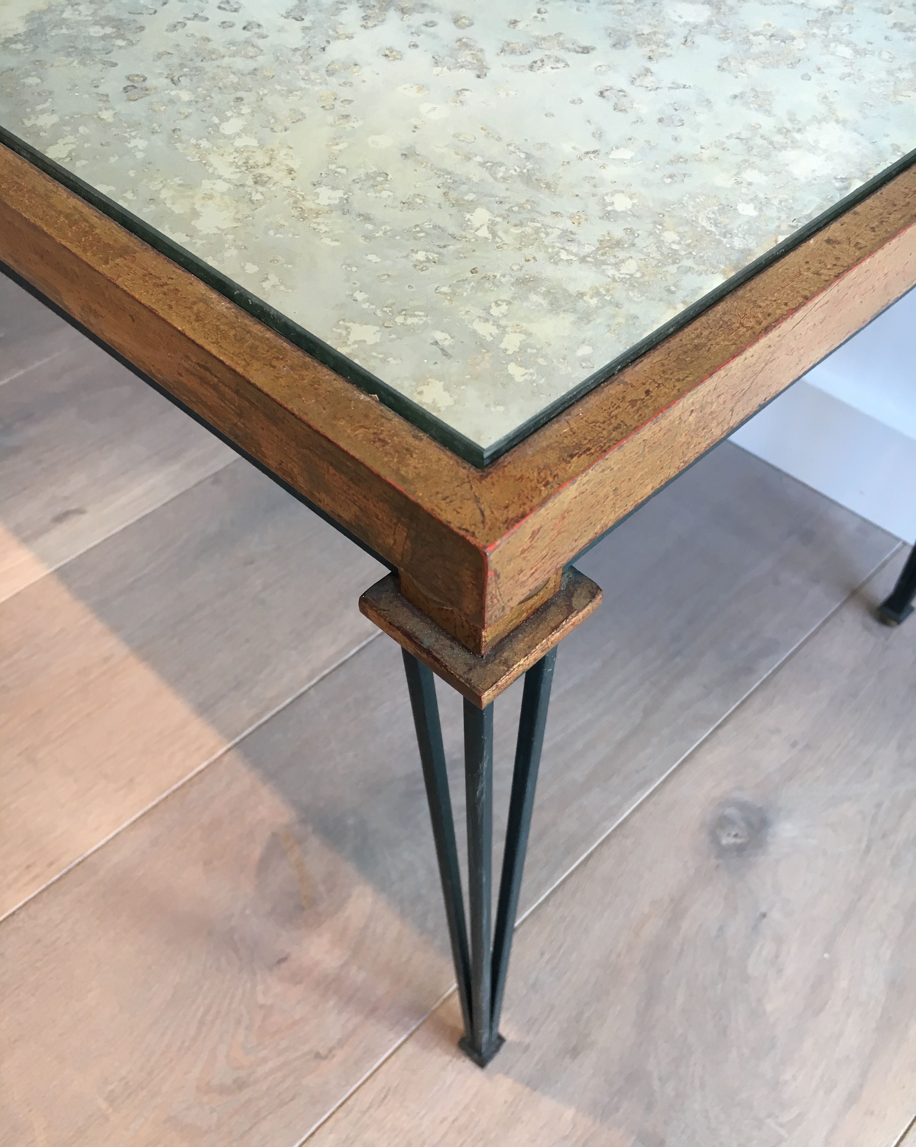 Patinated and gilded steel coffee table in the style of Jacques Quinet.