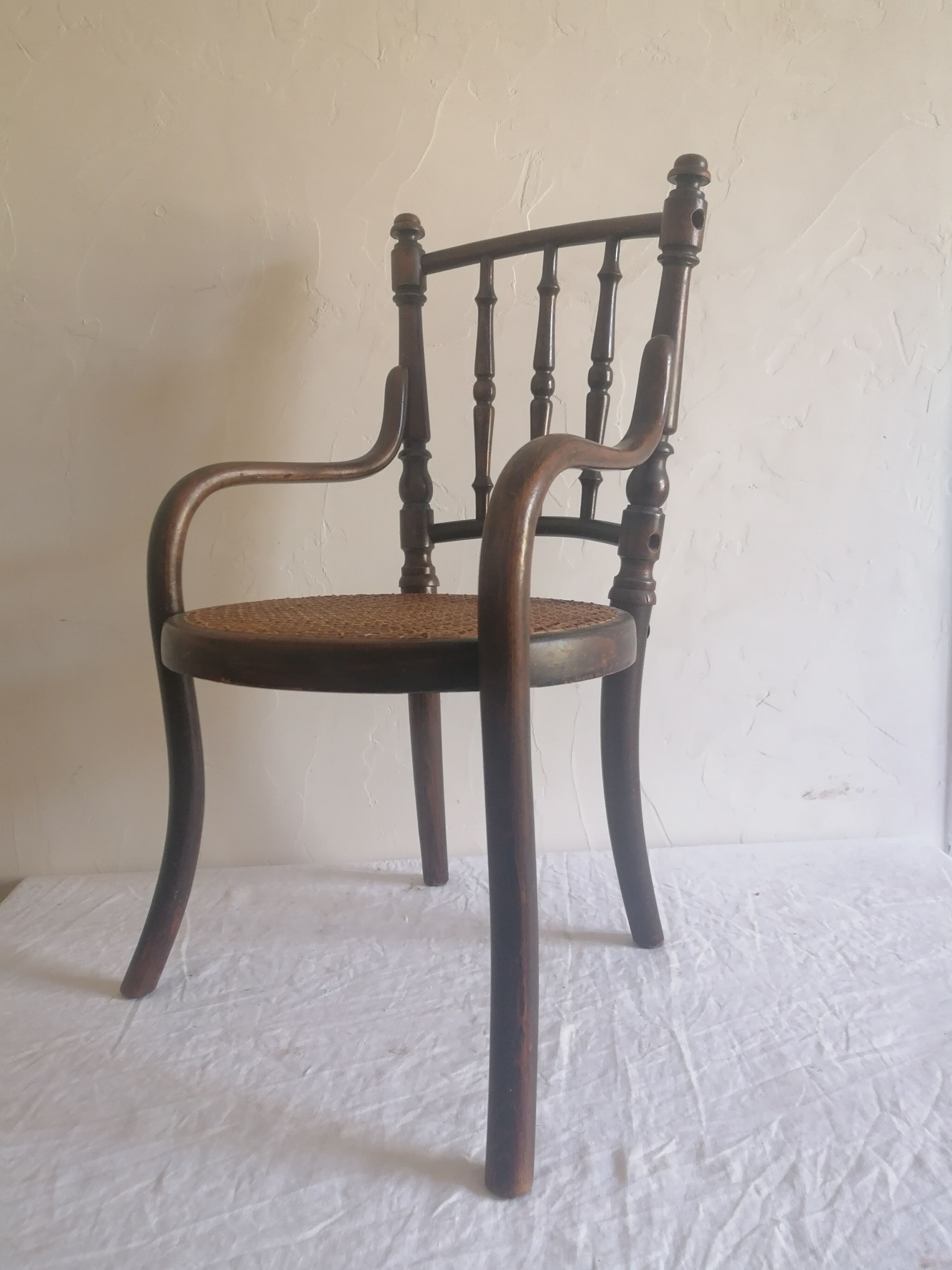 Old children's armchair in curved wood. Fischel