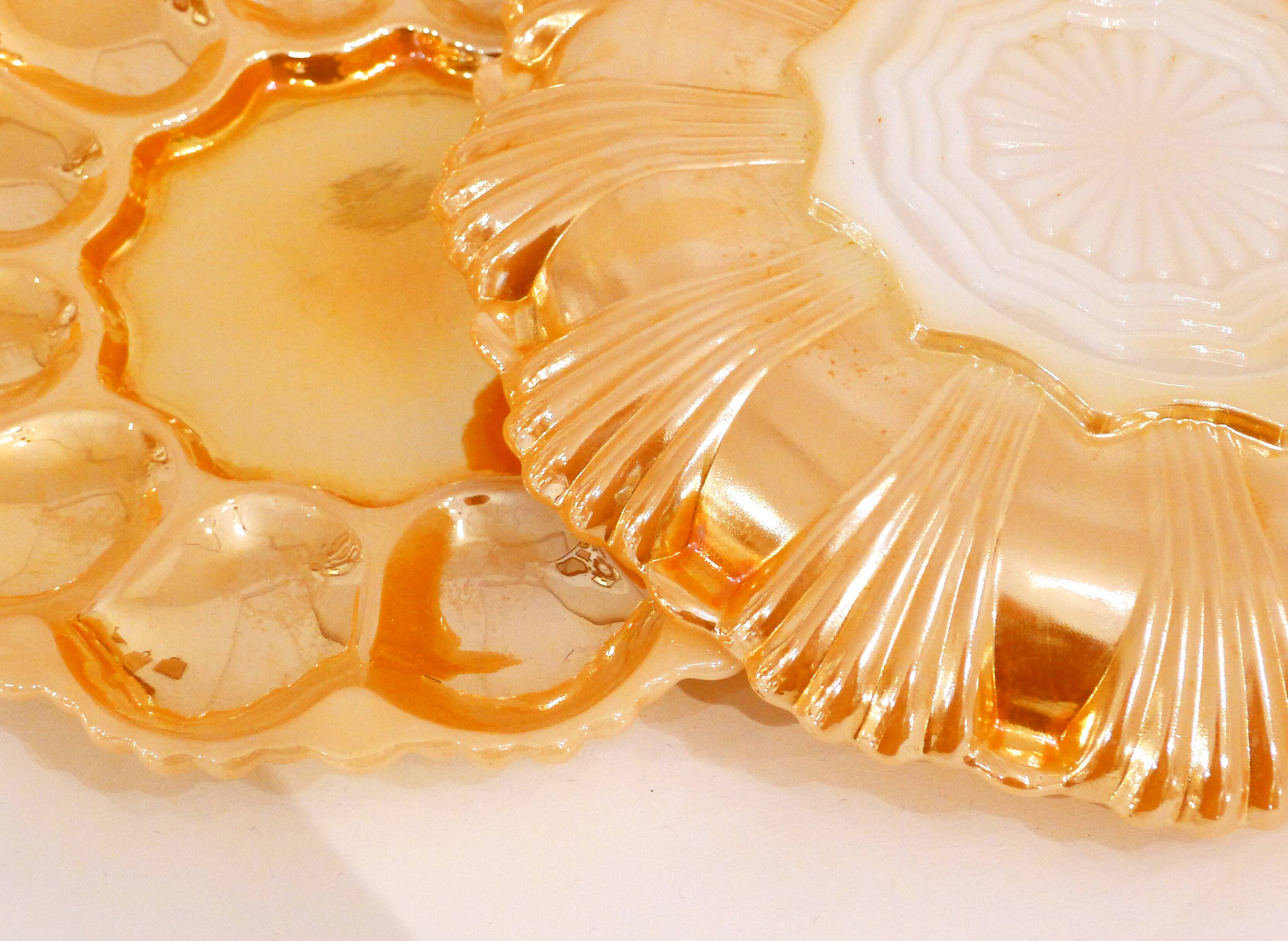 Pair of iridescent orange glass egg plates