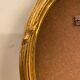 Golden oval wooden frame