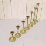 Seven candle holders in golden brass vintage trend