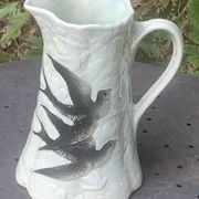 Jade green ceramic barbotine vase with swallows.
