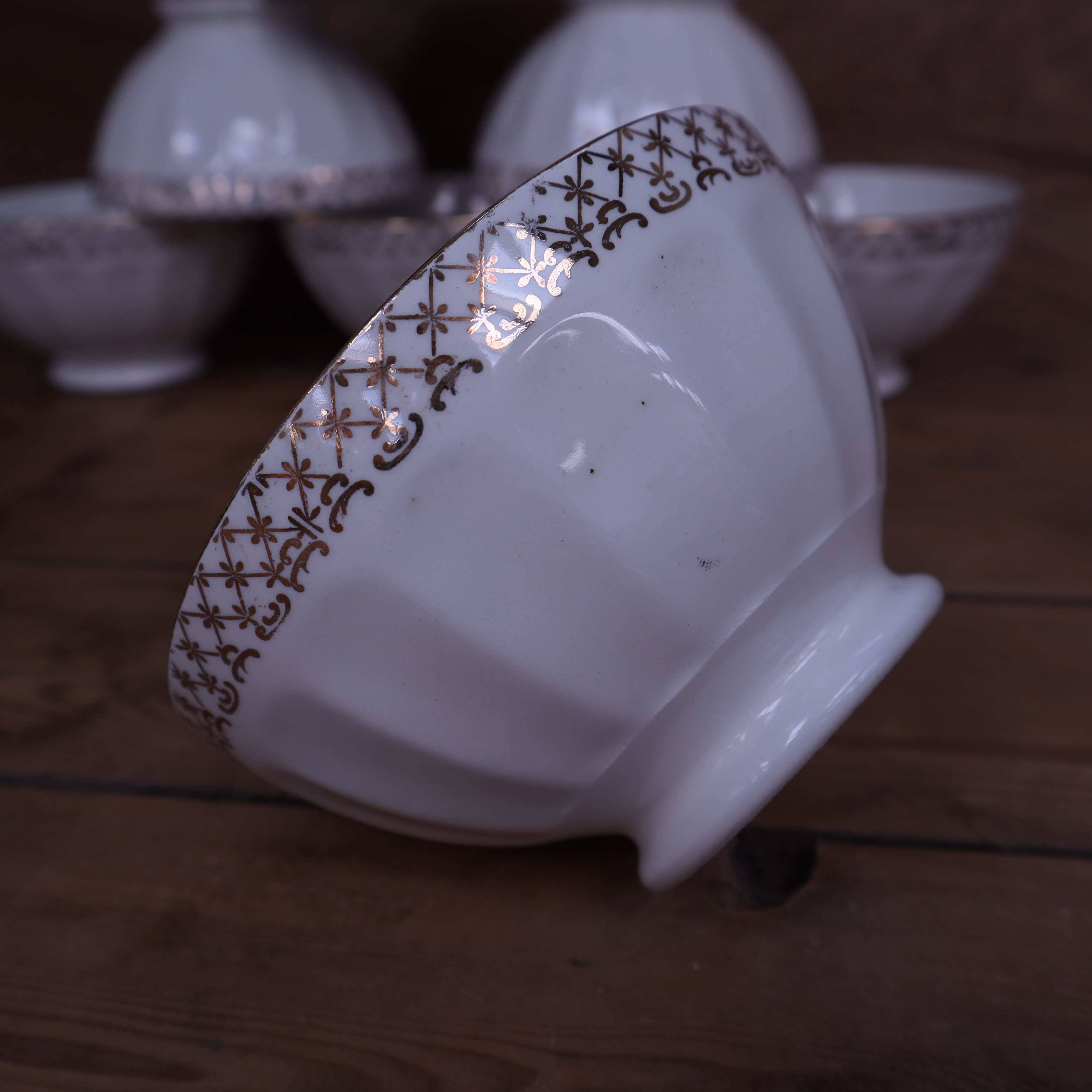 Antique white ribbed porcelain bowl with gold frieze