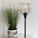 Table lamp with an antique star-shaped globe and a black base