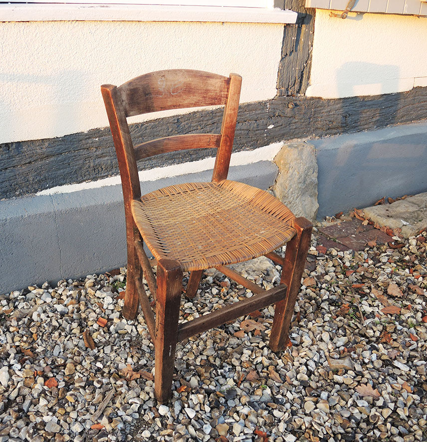 Old woven straw children's chair