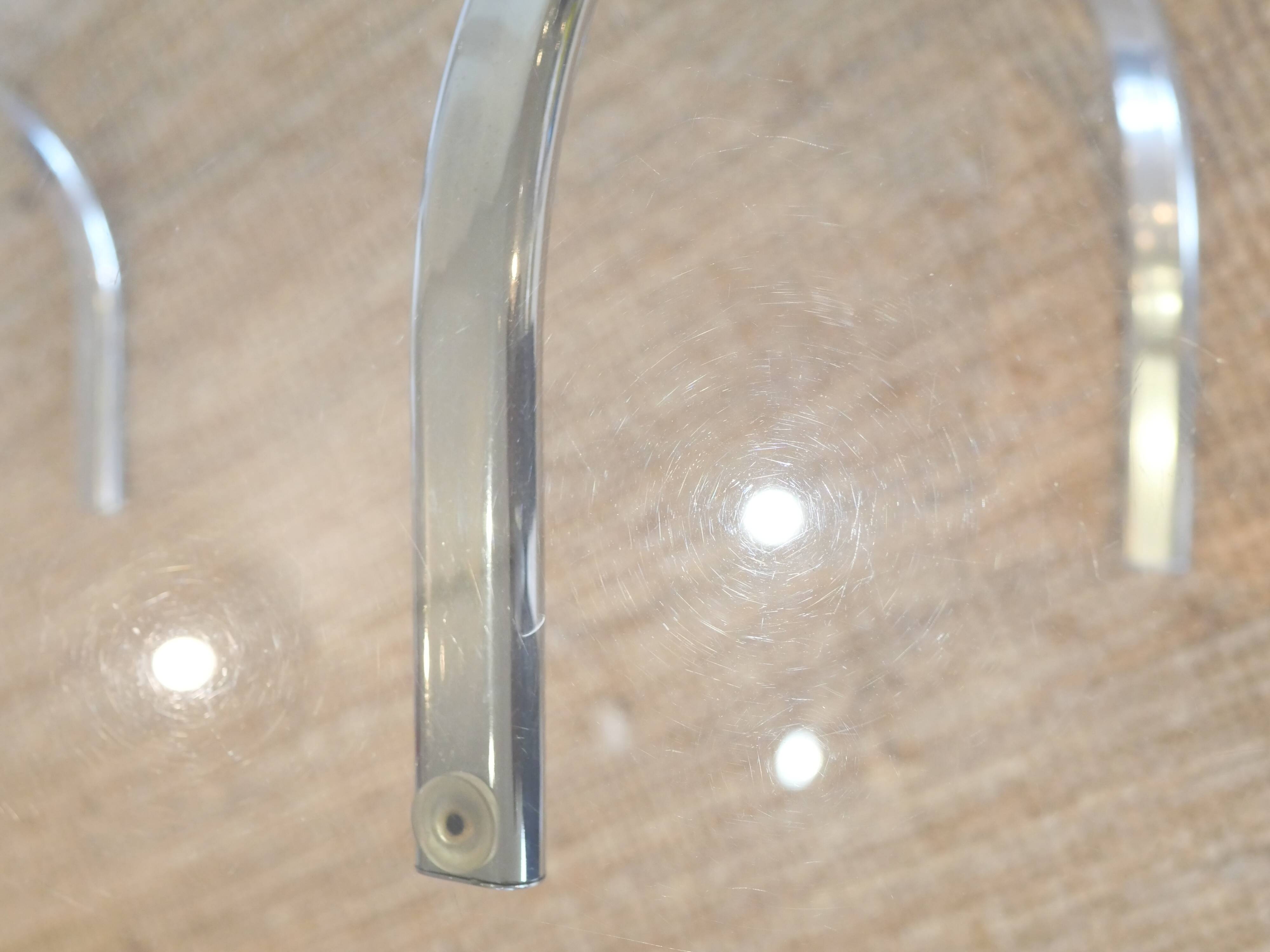 Dining table with smoked glass top and chrome base.