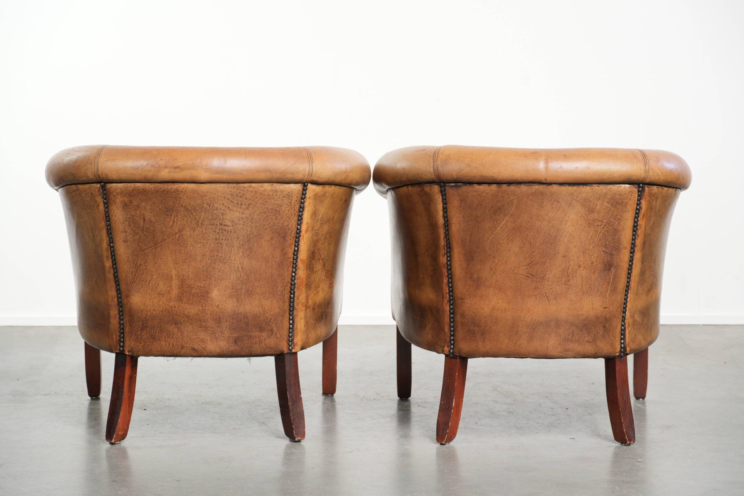 Set of two vintage sheepskin club armchairs with a beautiful light colour
