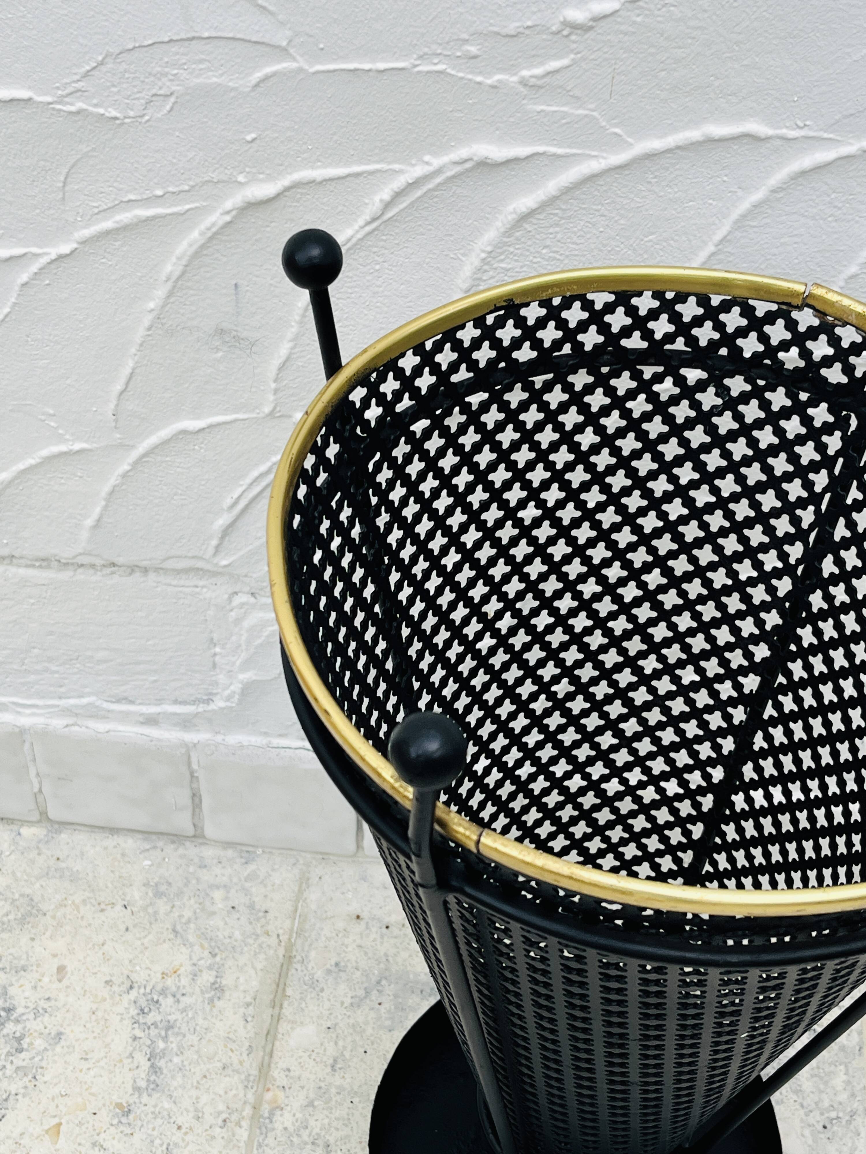 Vintage black perforated metal and brass umbrella stand