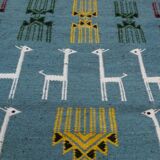 Blue carpet with gazelle patterns woven by hand