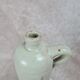 Antique beige glazed stoneware bottle from the 19th century, with a handle, vintage decor.