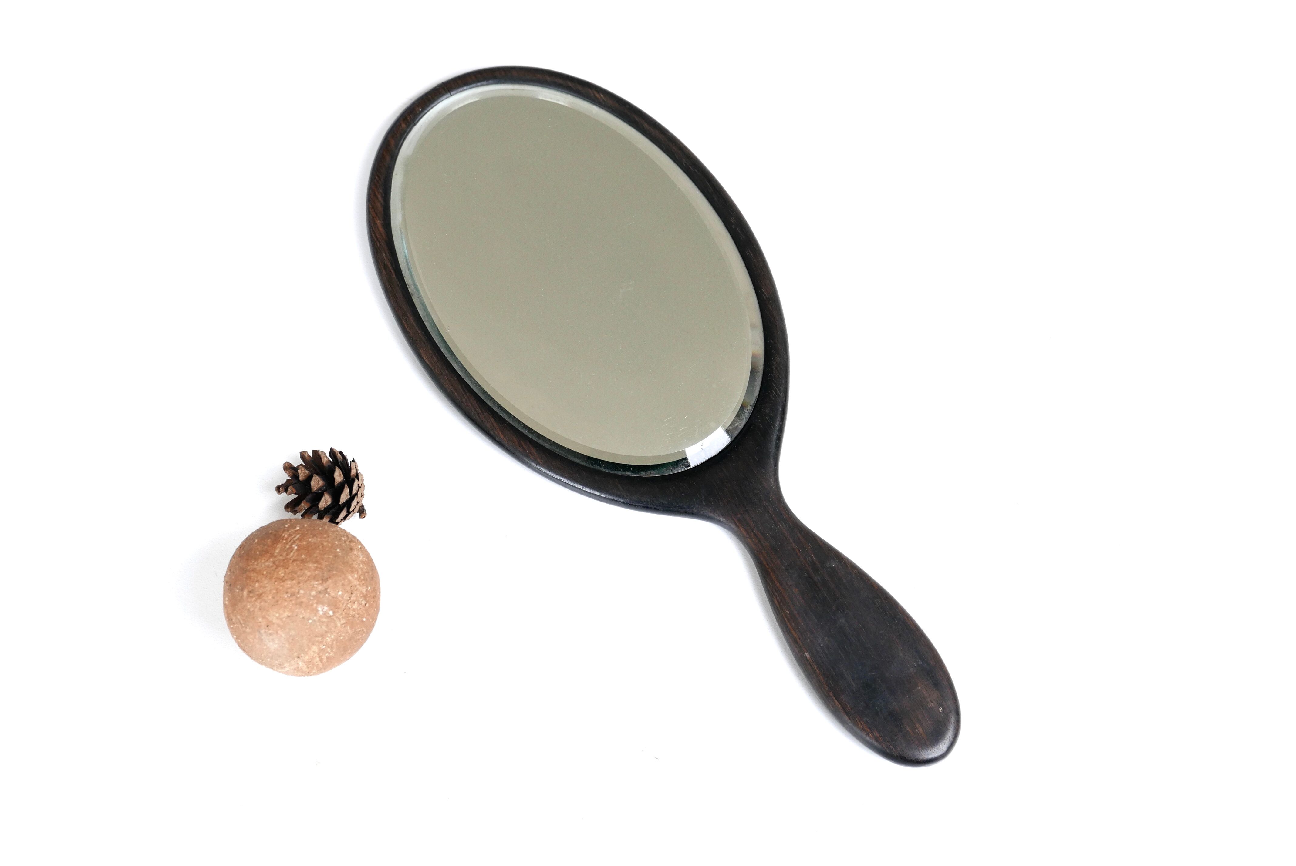 Napoleon III bevelled hand mirror in ebony, 30.5 x 13 cm