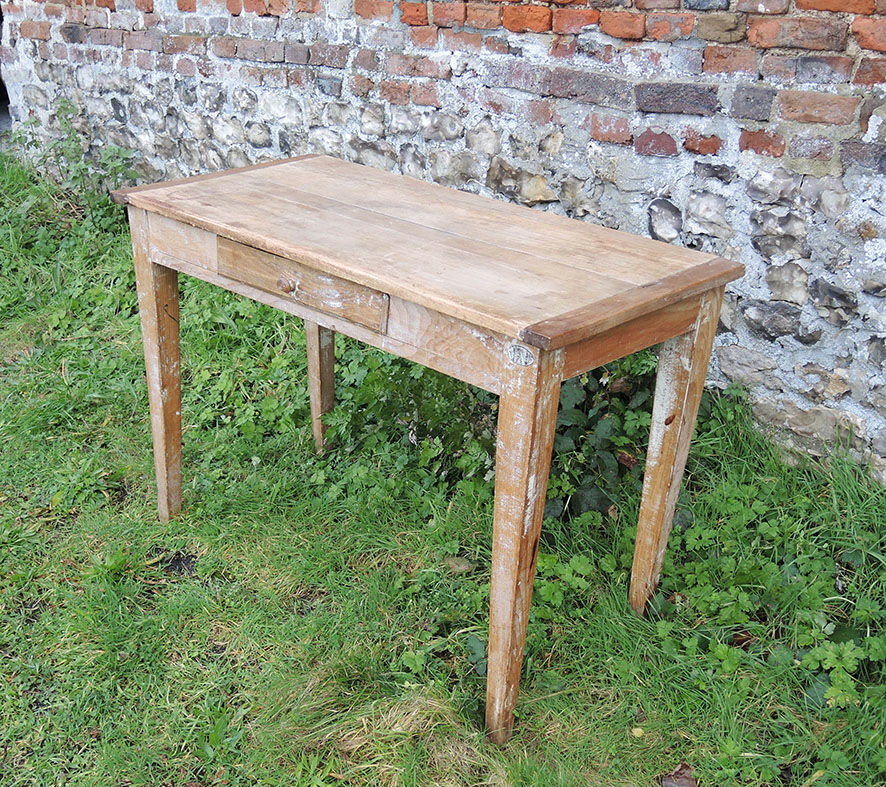 Old wooden farmhouse table with drawer
