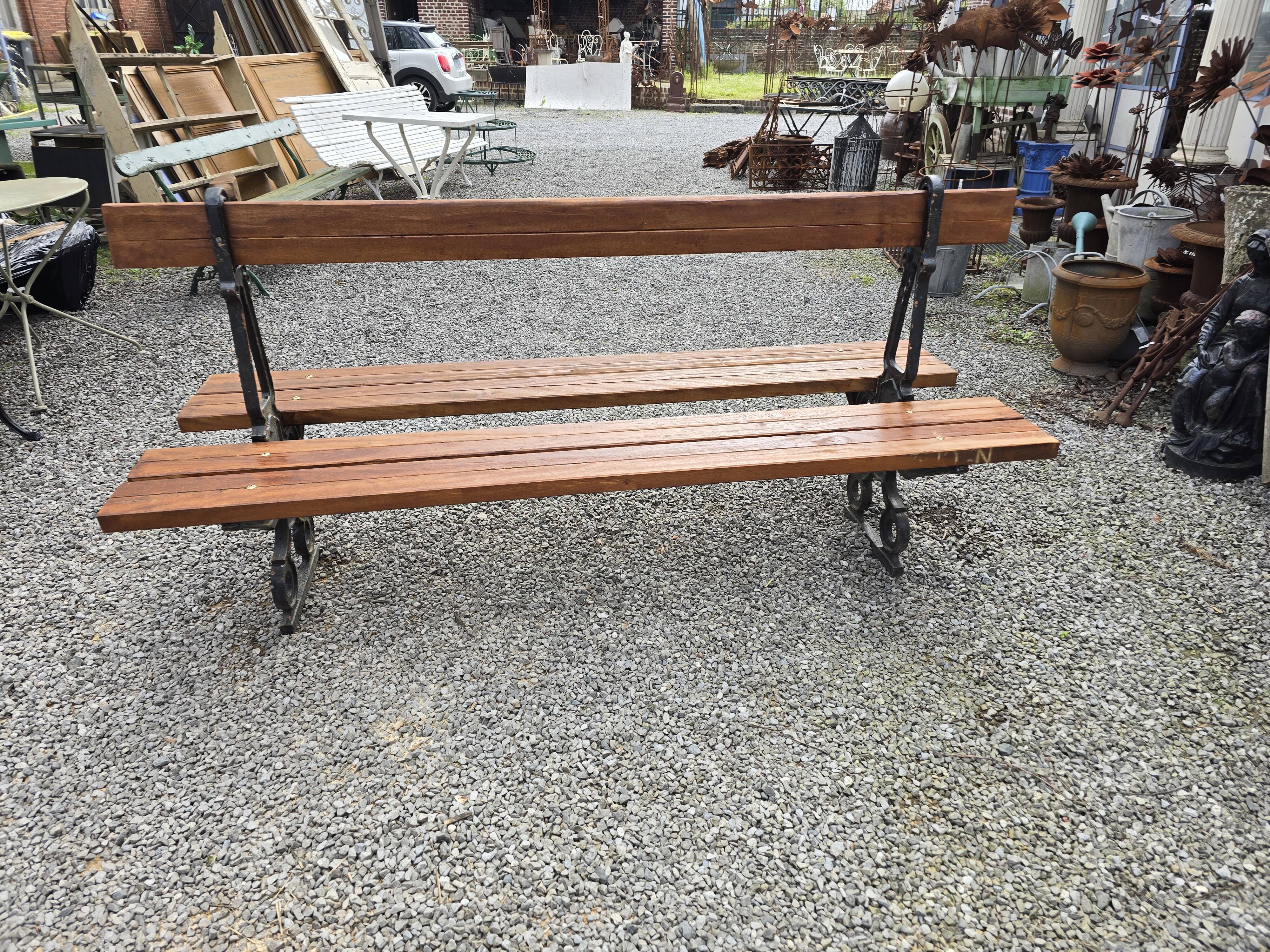 Antique double garden bench from the city of Paris in cast iron and wood