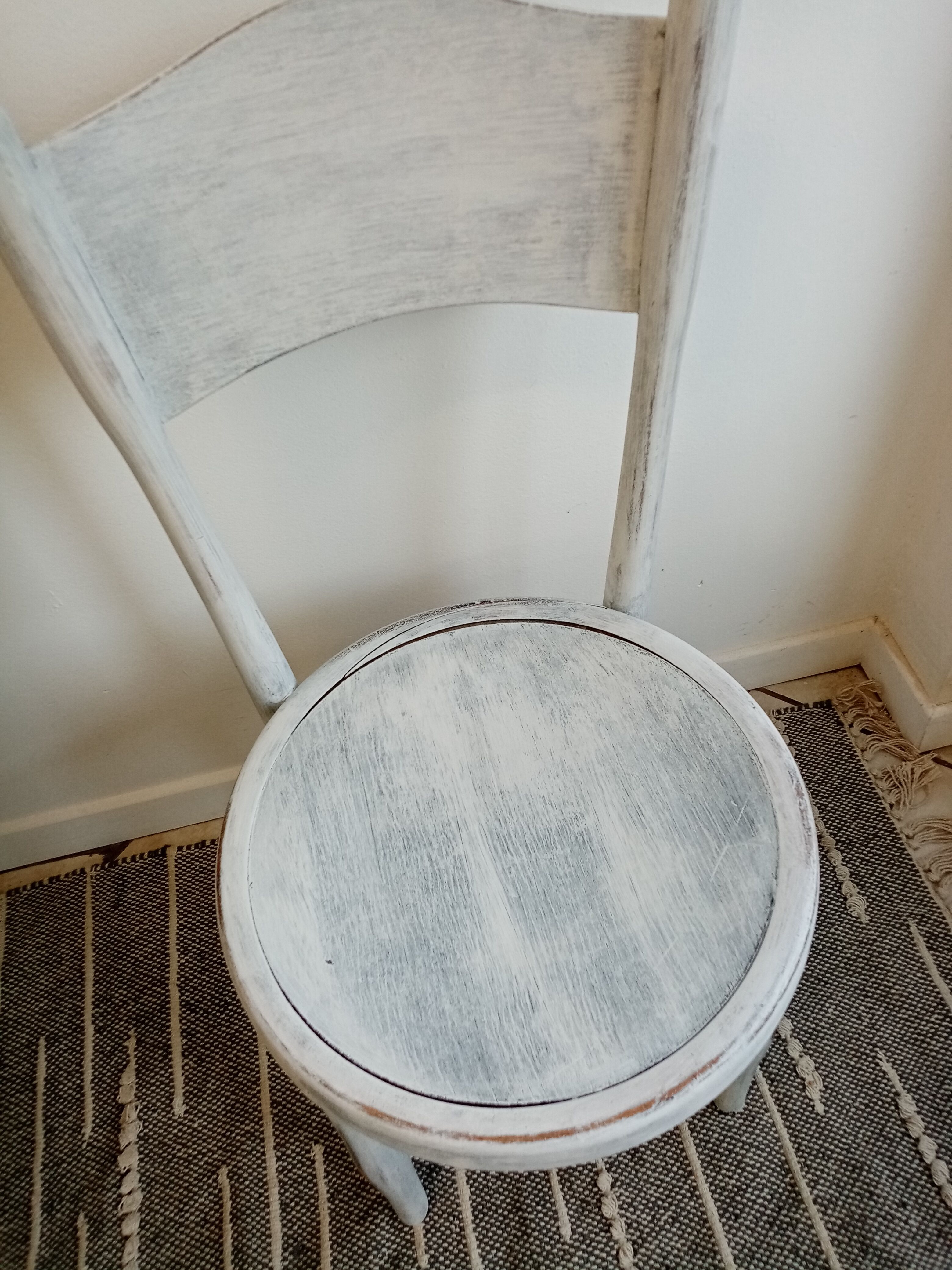 White antique children's chair in patinated wood