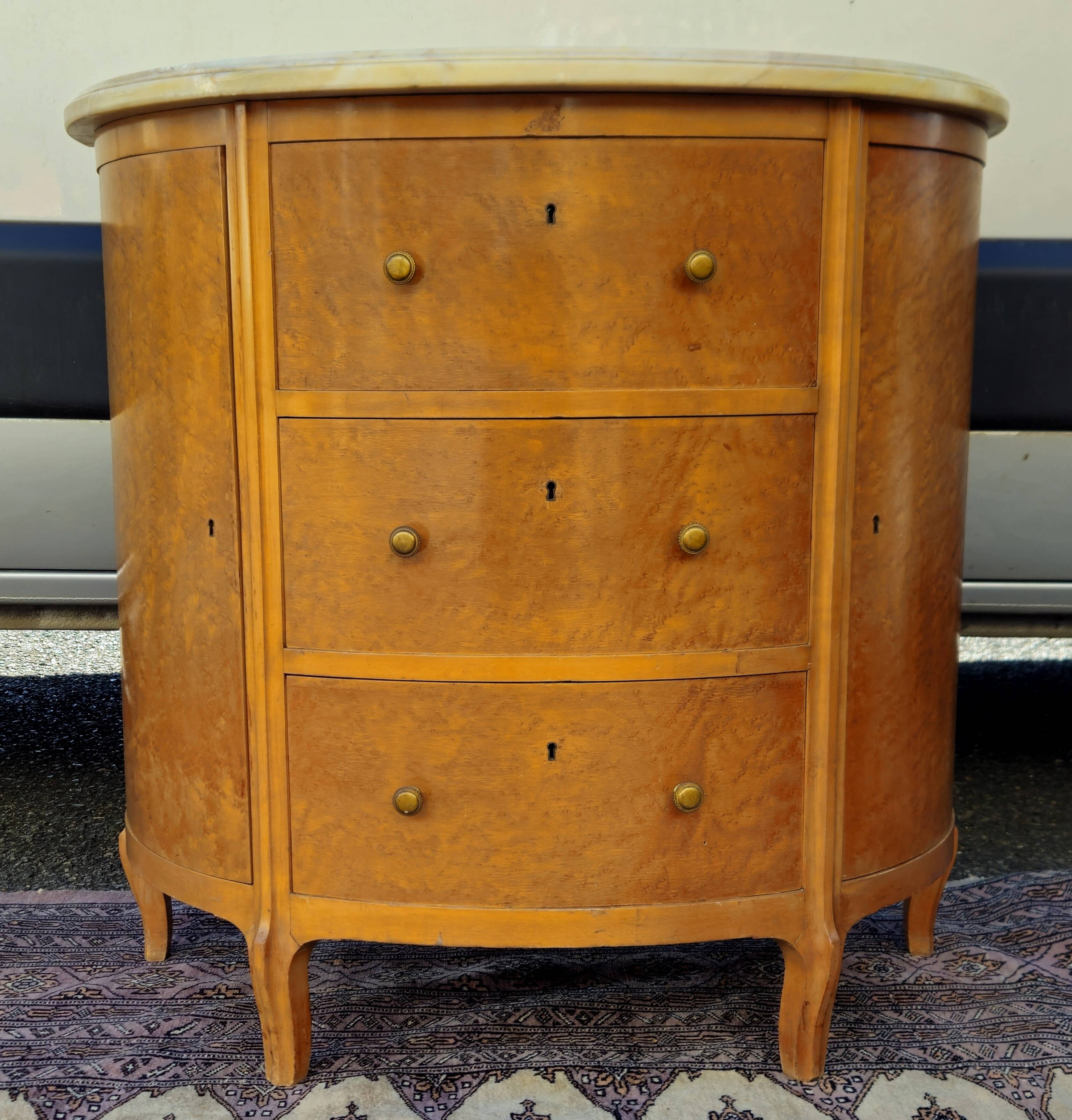 Half-moon commode in burl wood with a marble top.