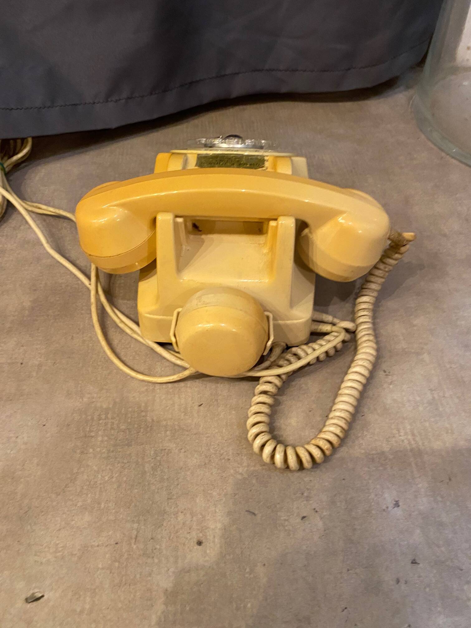 Old dial telephone from the 80s temat quimper bakelite yellow and beige
