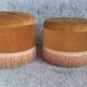 False pair of round Napoleon III poufs in ochre velvet, tufted with fringes.