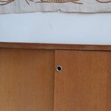 1970s low furniture in wood and metal with sliding doors.