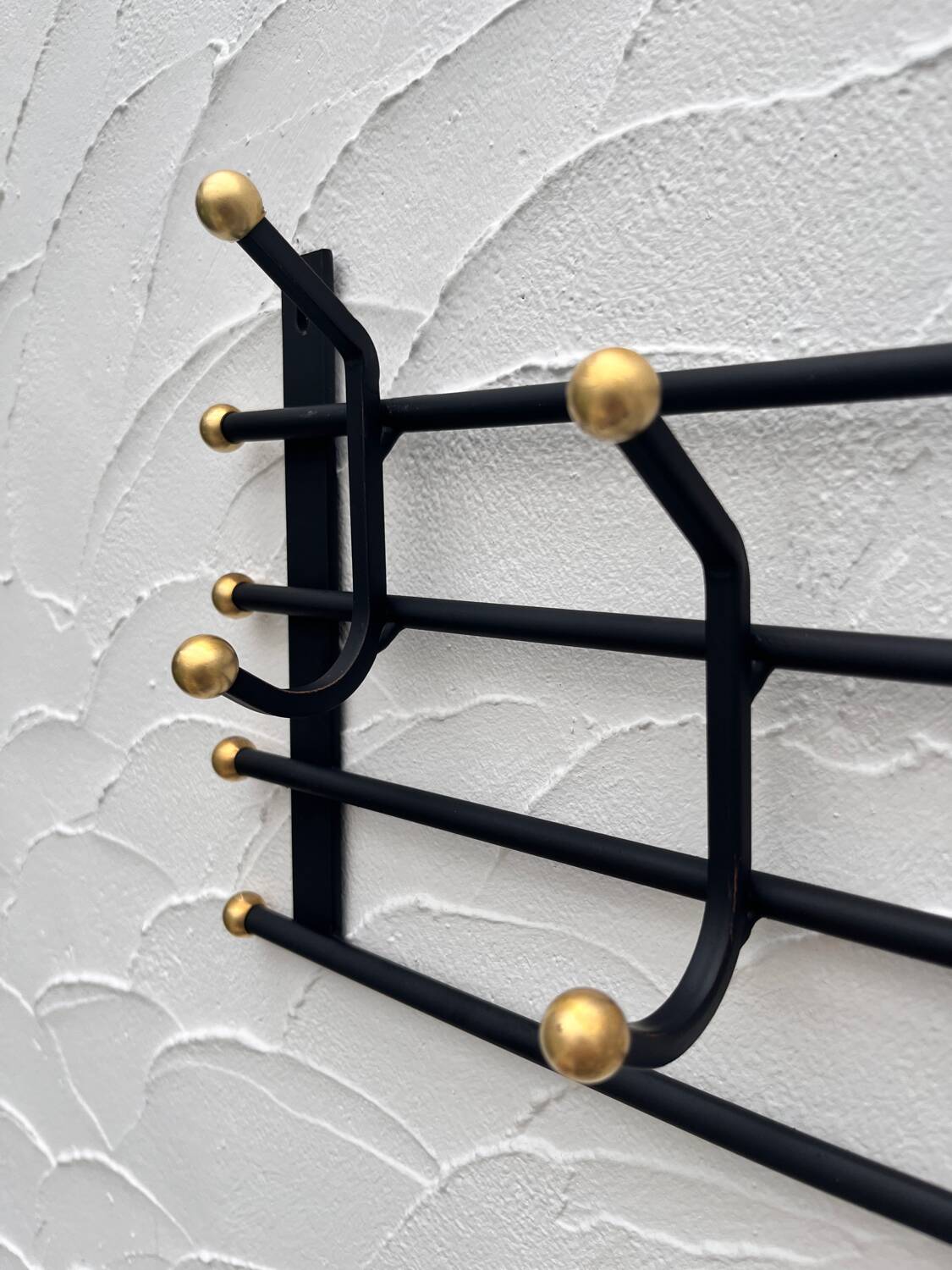 Iron and brass coat rack
