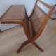 Cane magazine rack with light wood shelf