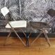 Duo of white and brown Piretti plia chairs