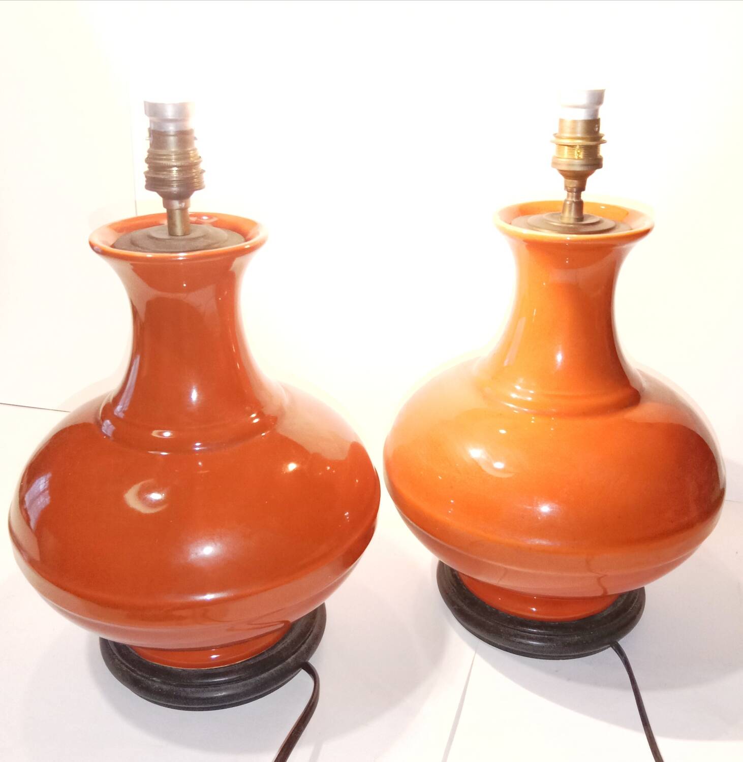 Pair of ceramic lamp bases in the shape of orange gourds.