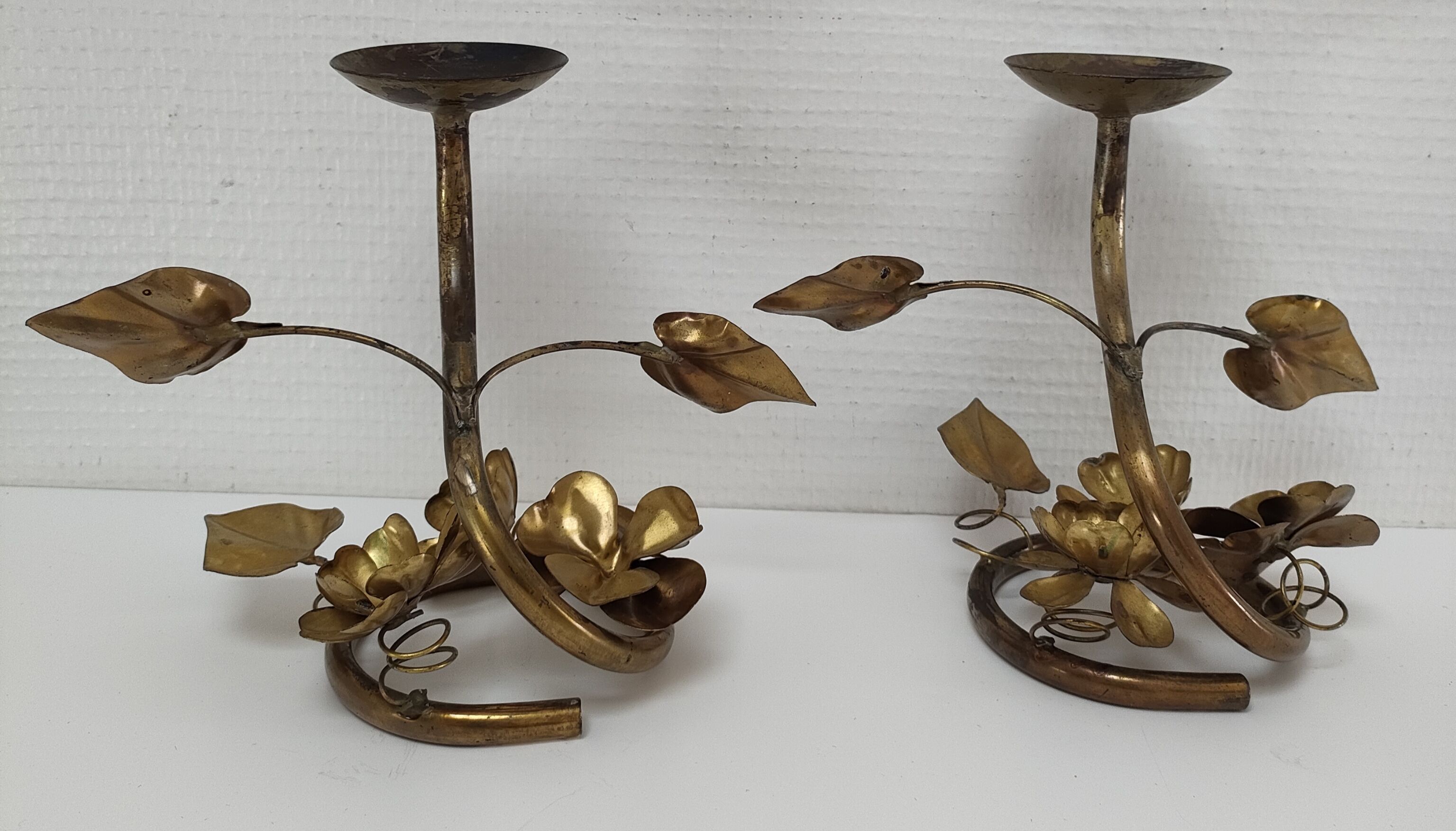 Pair of brass candle holders decorated with patinated metal flowers