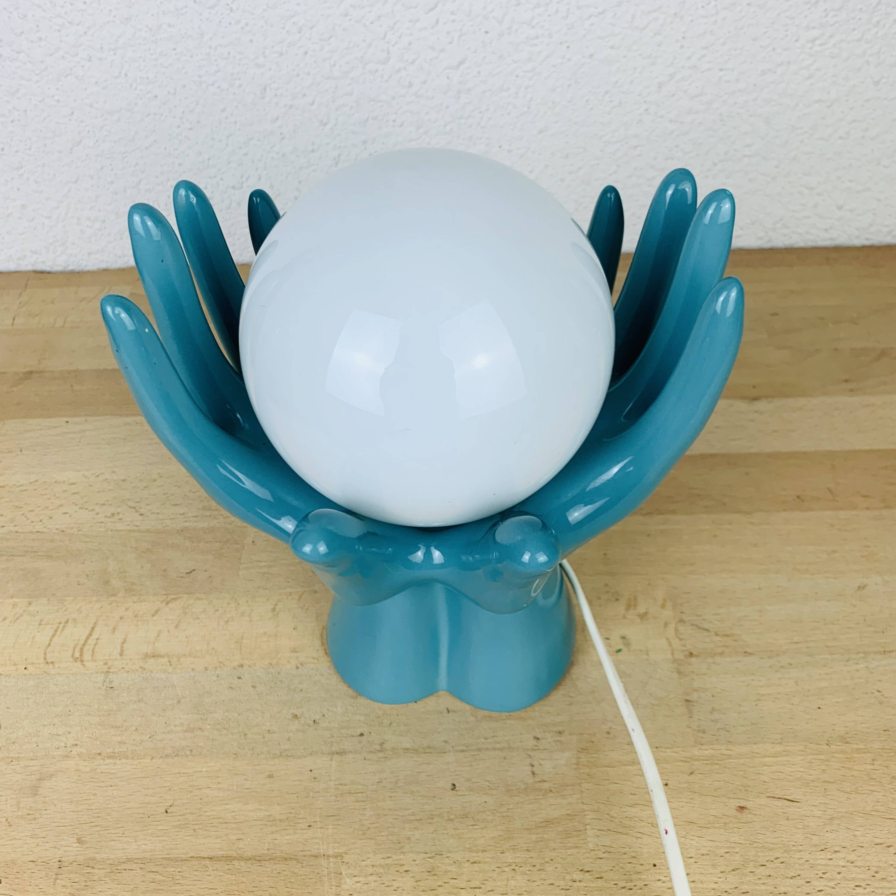 Blue ceramic hands lamp and glass globe