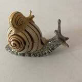 Porcelain figurine snail and its small