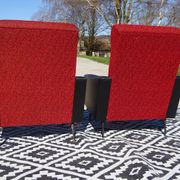 Pair of vintage armchairs in black faux leather and red fabric.
