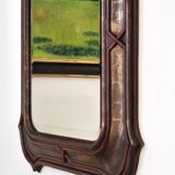 Italian sculpted mirror, patinated brown and gold wood, architectural frame from the 1960s.