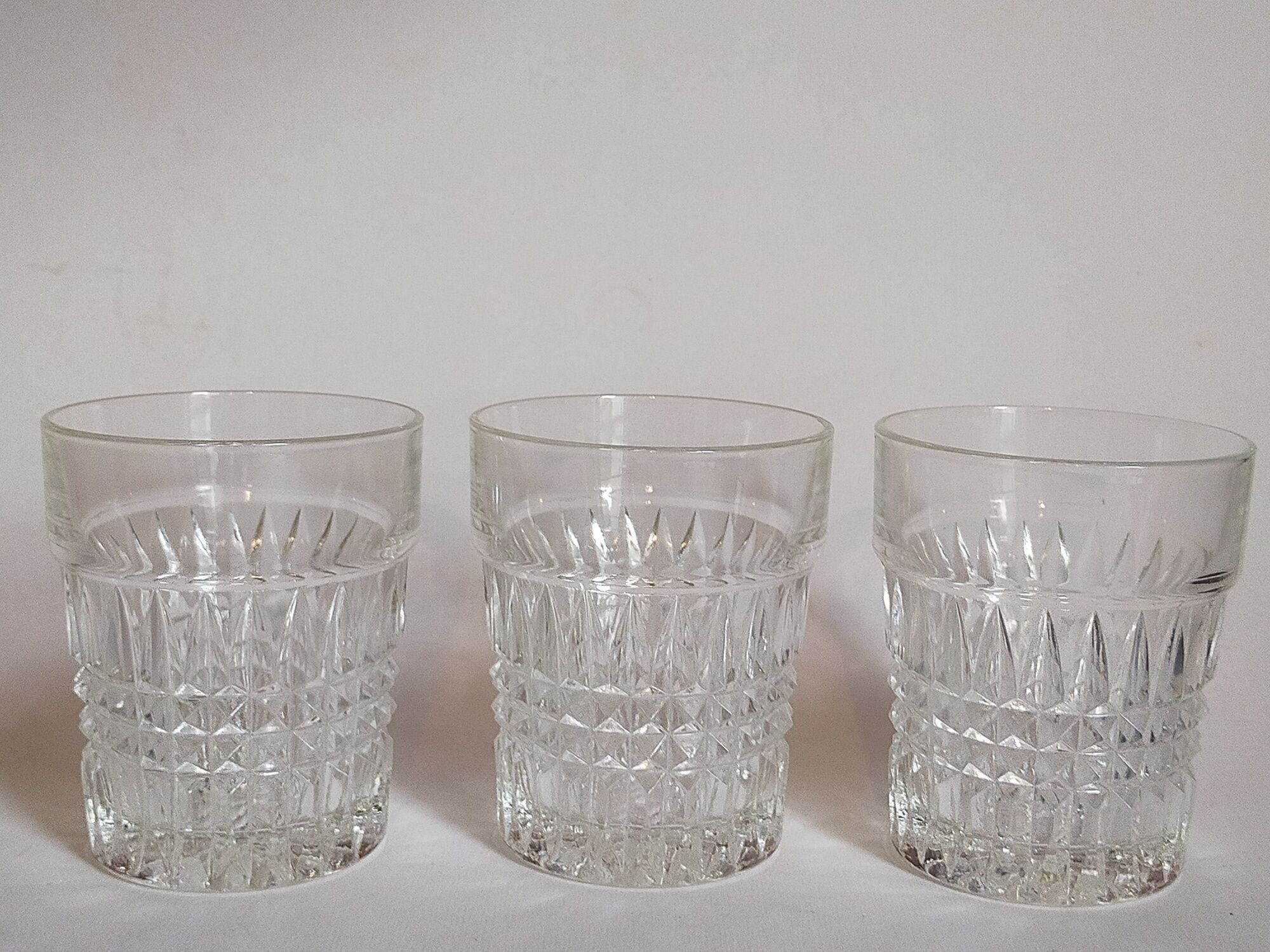 Trio of vintage whiskey glasses in pimpled glass