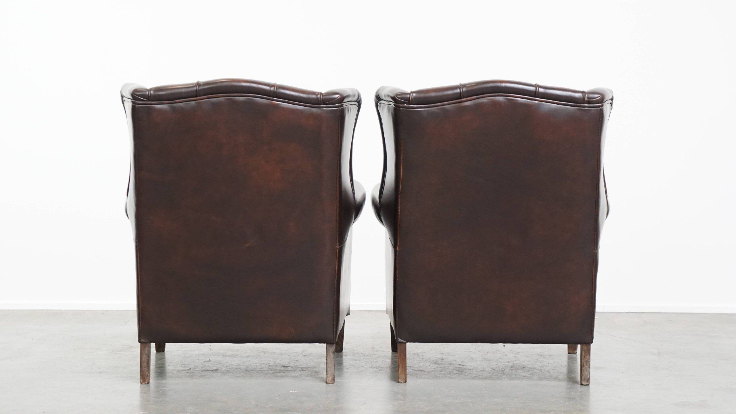 Comfortable and very beautiful set of 2 cow leather wingback armchairs in English style