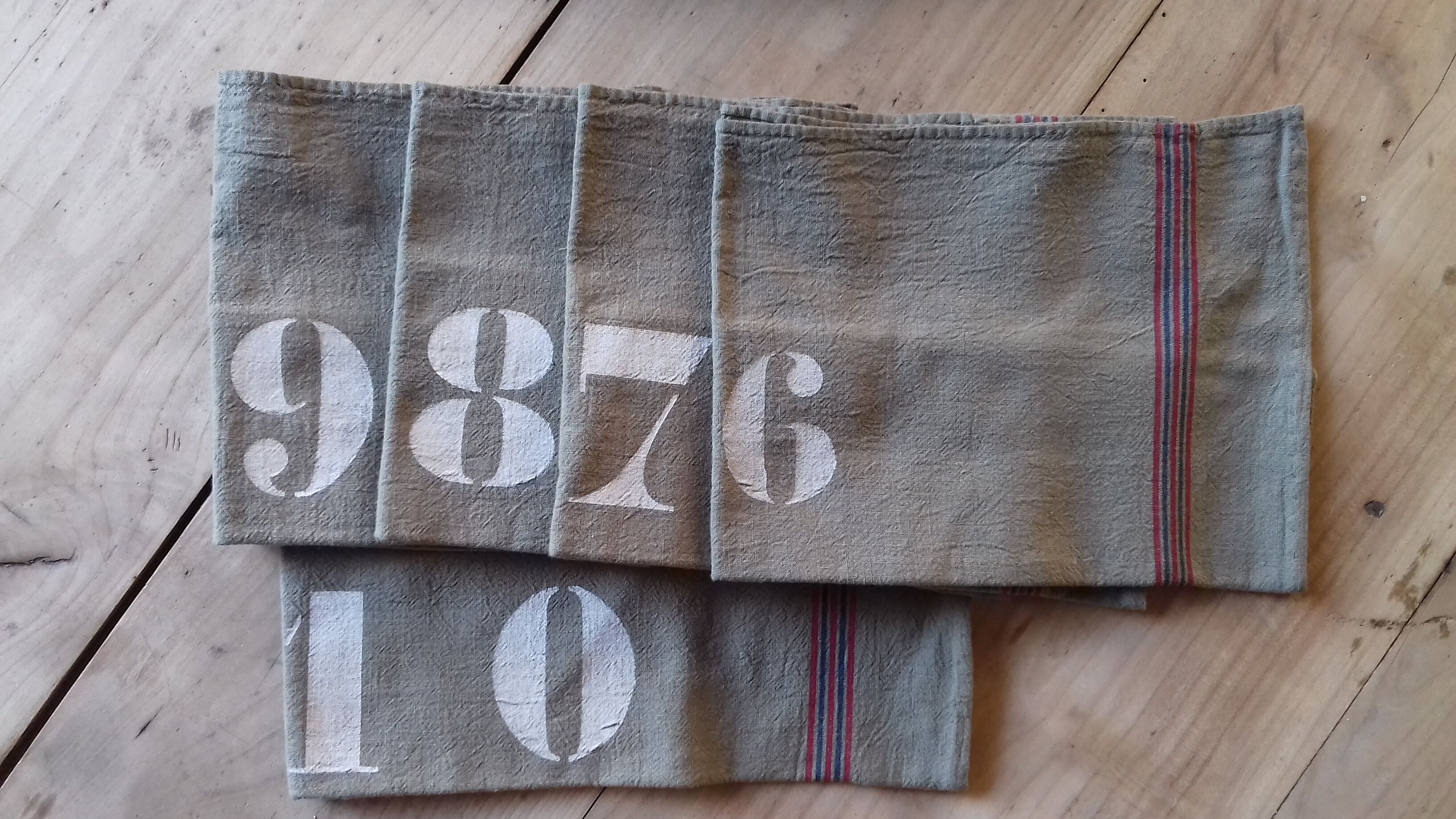 10 numbered khaki tea towels