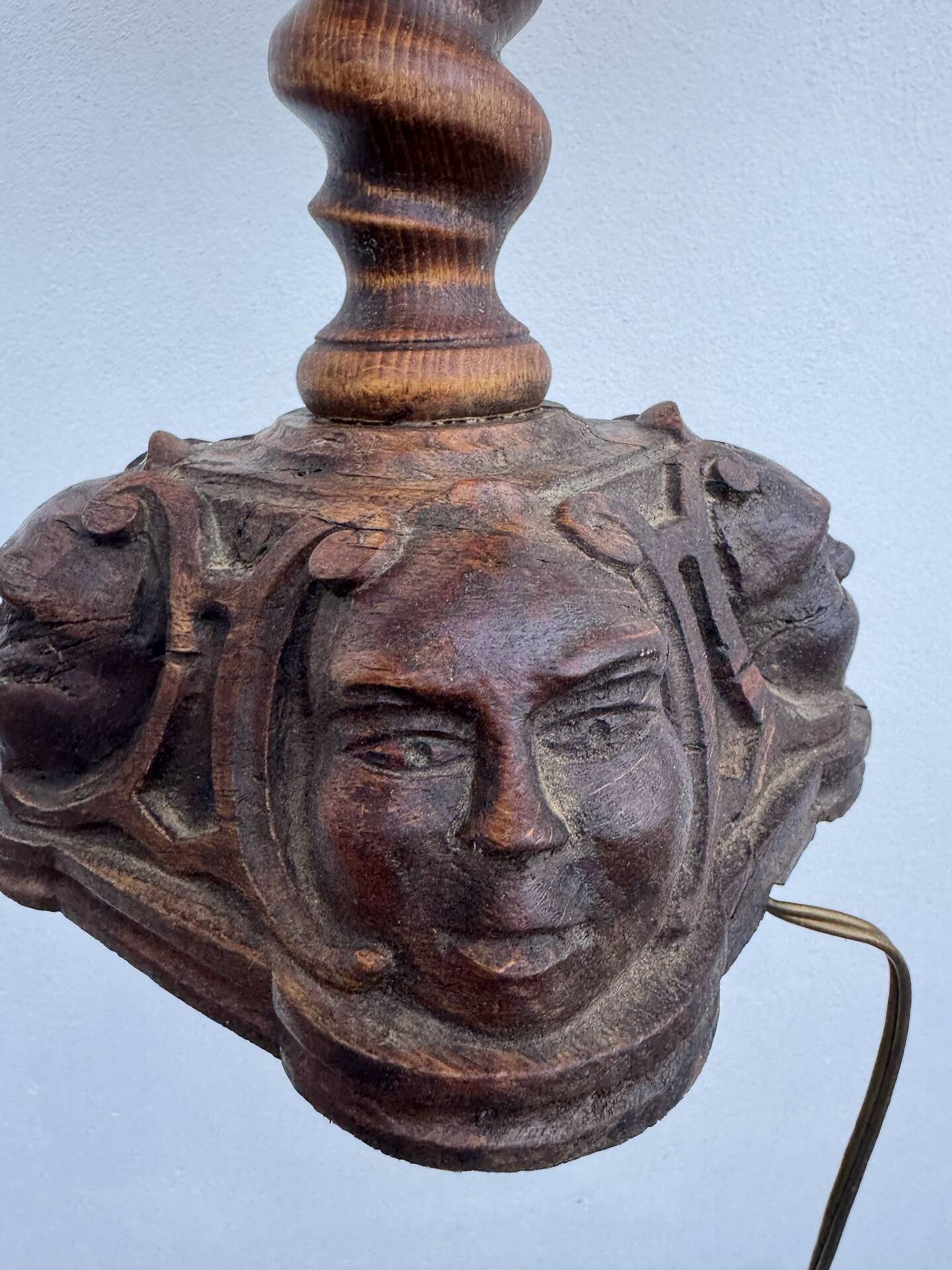 Sculpted wooden lamp with faces, antique.