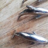 Set of three silver metal dolphin place markers