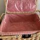 Large Suitcase, wicker picnic basket and red Vichy