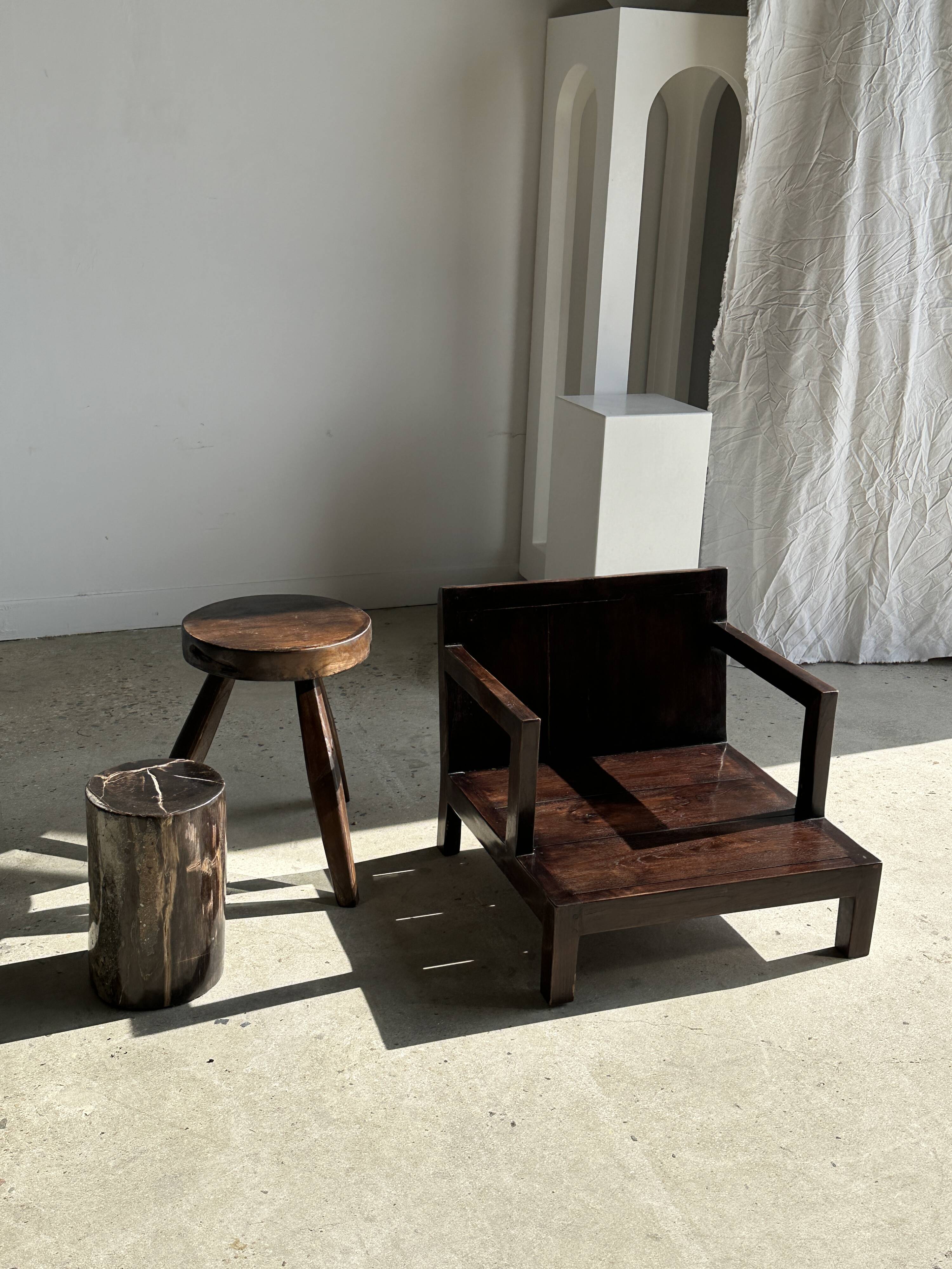 Small low armchair in varnished brown wood