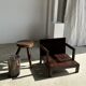 Small low armchair in varnished brown wood