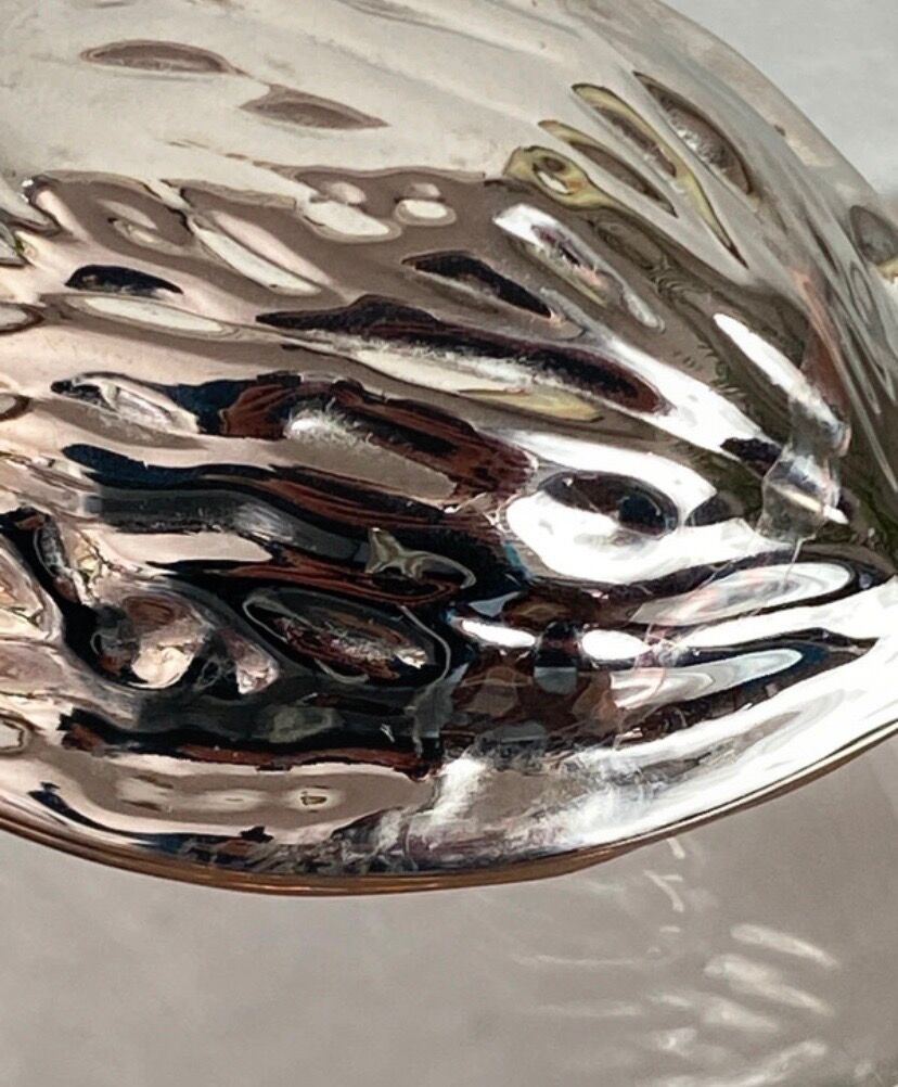 Nutcracker in the shape of a nut in silver-plated metal.