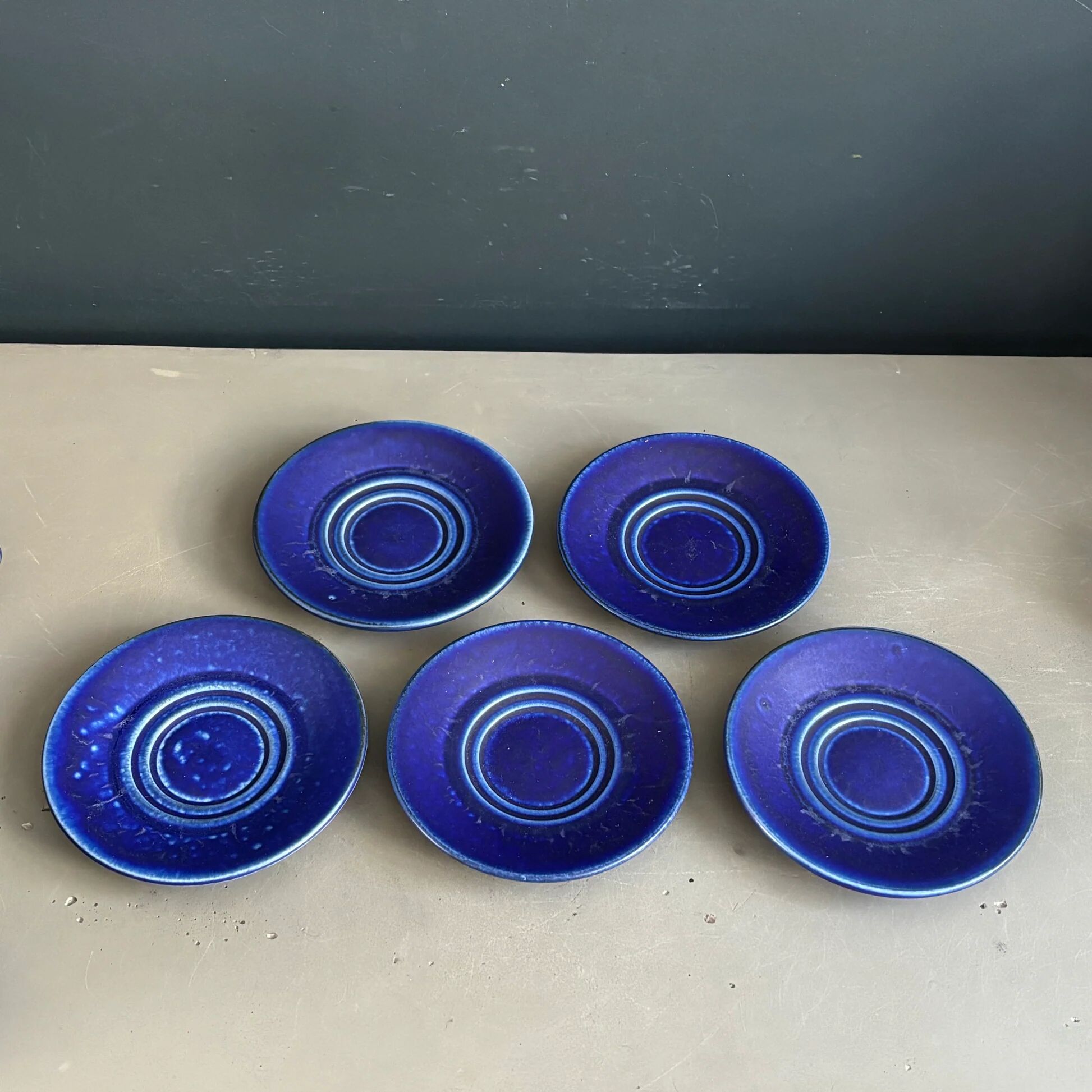 Set of 5 blue Klein ceramic tea cups with saucers.