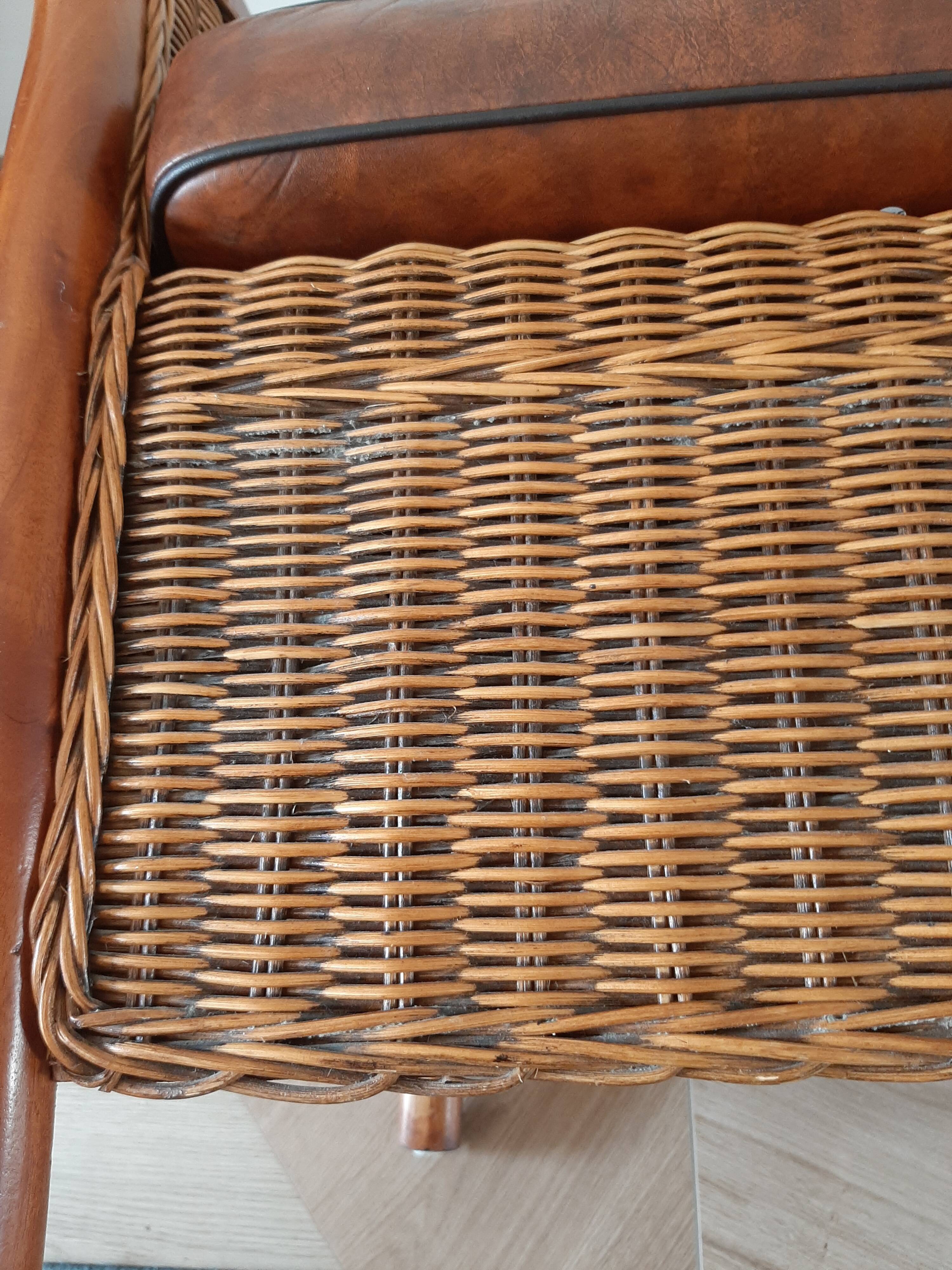 Armchair in woven rattan and exotic wood