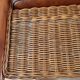 Armchair in woven rattan and exotic wood