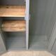 Curved wardrobe workshop locker made of wood repainted in grey.