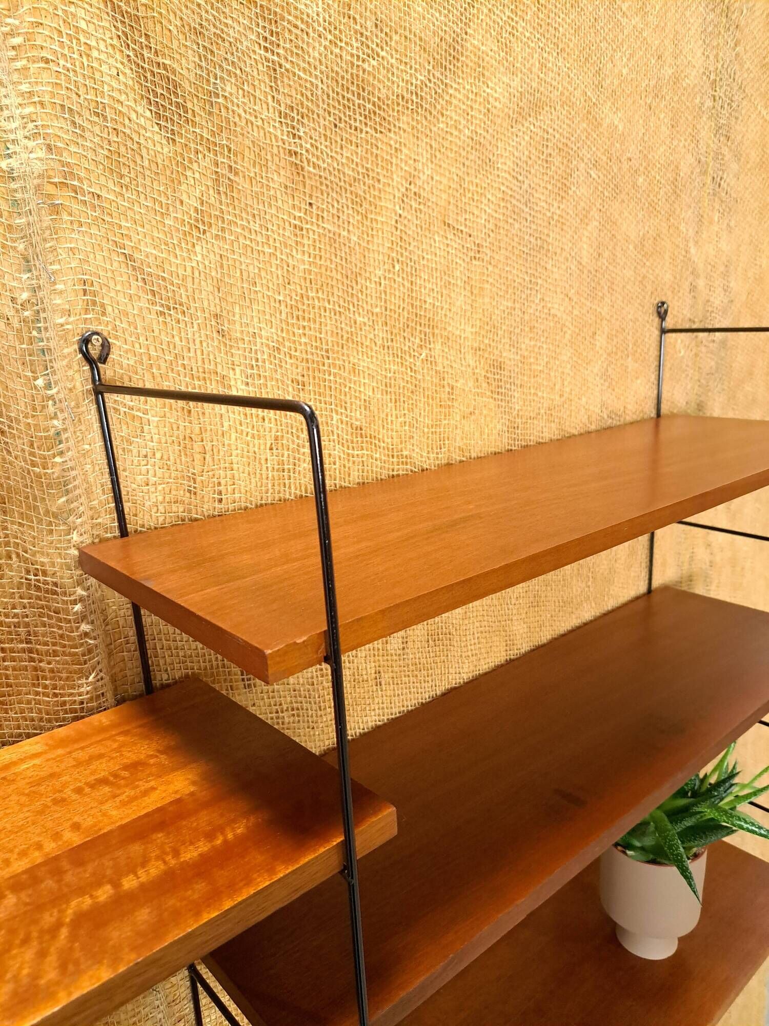 Wall rack with shelves and steel holders, dark wall system