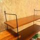 Wall rack with shelves and steel holders, dark wall system