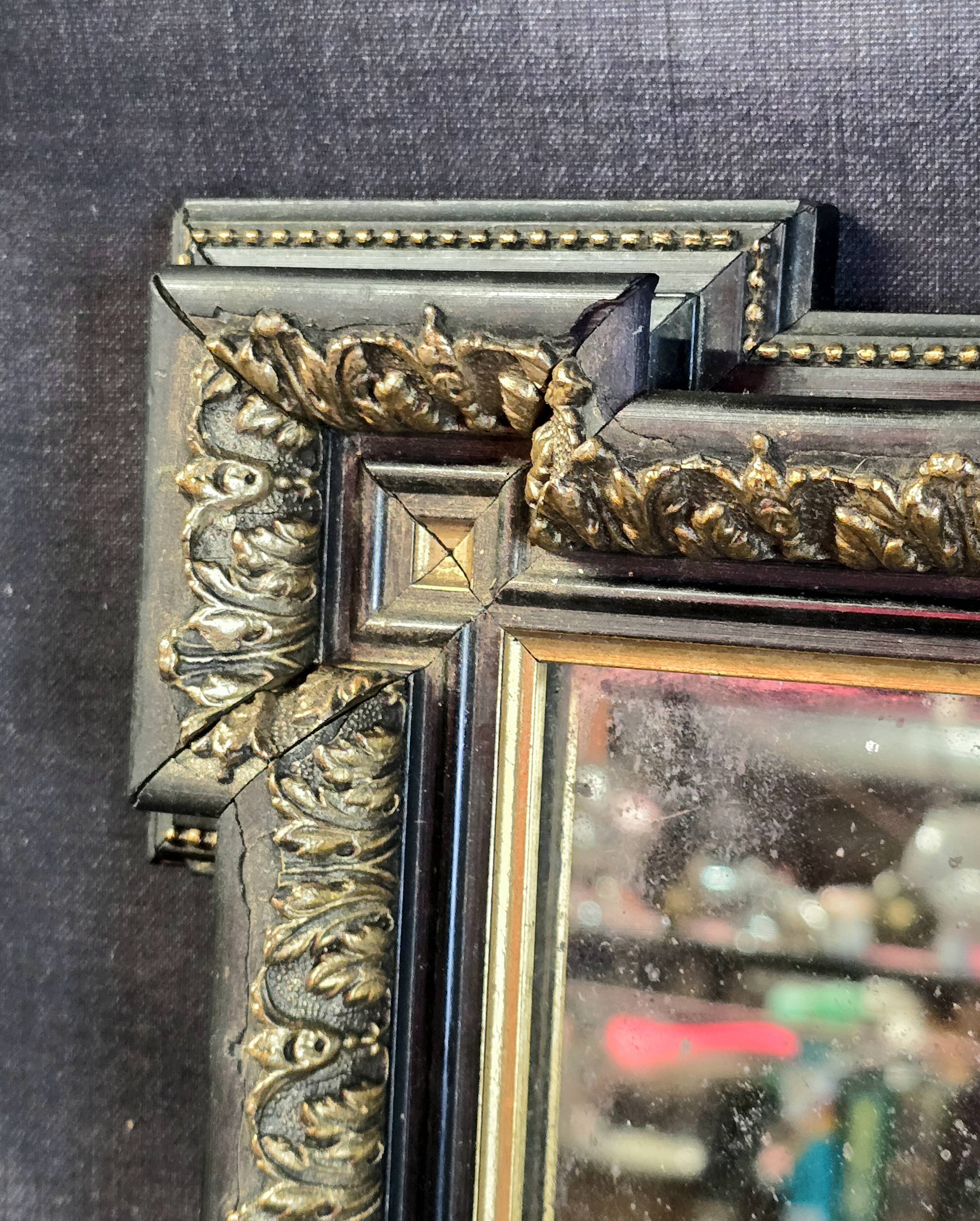 Napoleon III mirror in blackened wood and gilded decoration, second half of the 19th century.