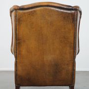 Sheepskin wing chair + XXL patinated footrest